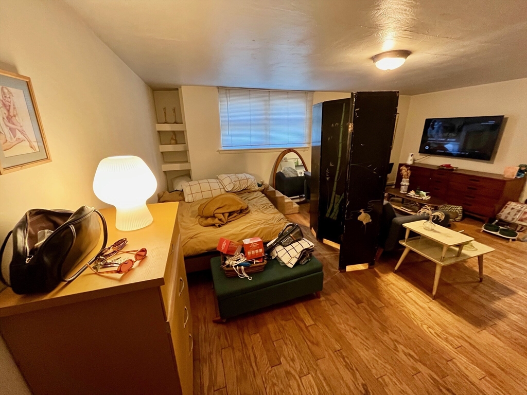 105 Chestnut Street, Unit 2B Brookline, MA 02445 - Photo 2 of 7 a living room with furniture and a flat screen tv
