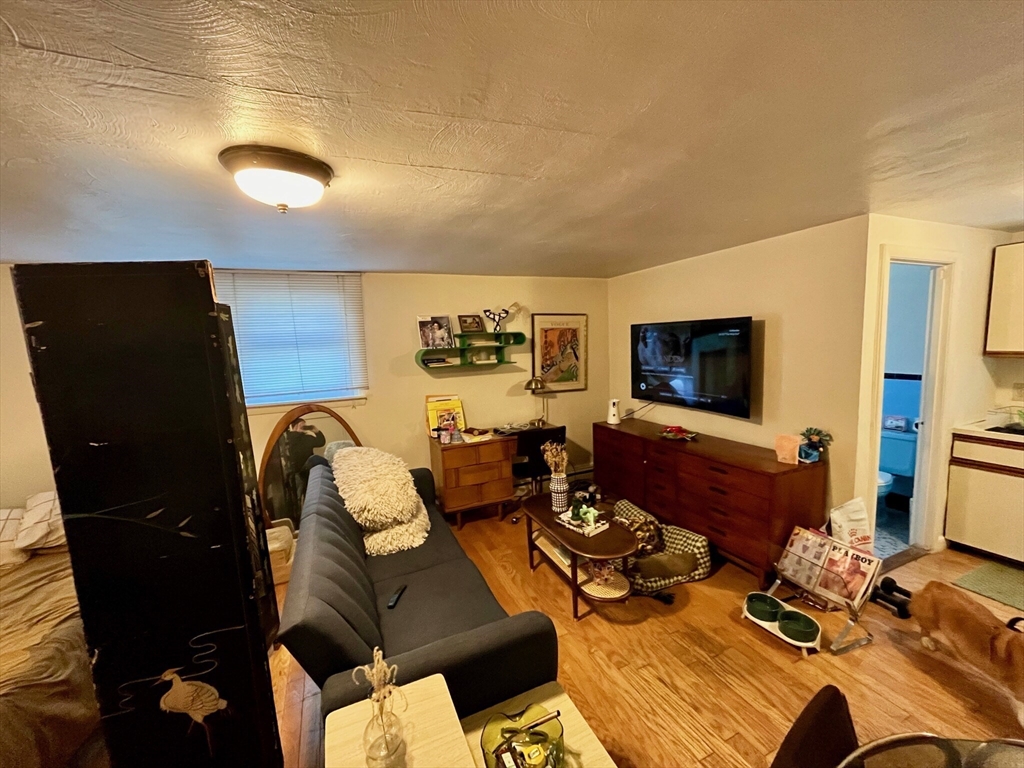 105 Chestnut Street, Unit 2B Brookline, MA 02445 - Photo 3 of 7 a living room with furniture and a flat screen tv
