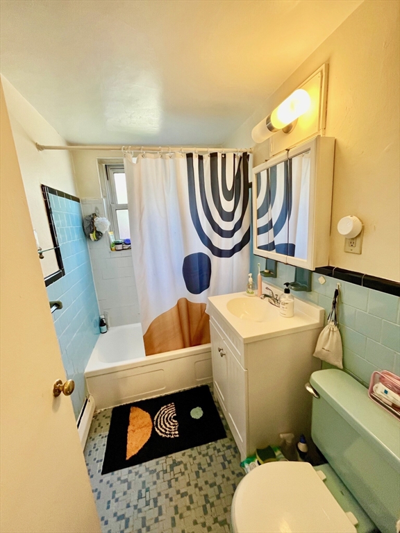 105 Chestnut Street, Unit 2B Brookline, MA 02445 - Photo 7 of 7 a bathroom with a toilet a sink and a mirror