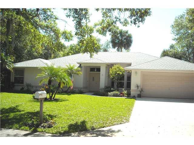 5 Miramar Road Sewall's Point, FL 34996 - Photo 1 of 24 a view of a house with a yard potted plants and a table