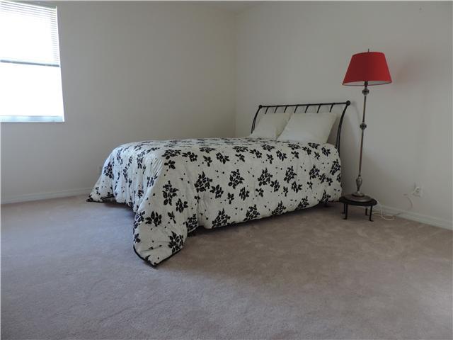 5 Miramar Road Sewall's Point, FL 34996 - Photo 12 of 24 a bed sitting in a bedroom next to a window