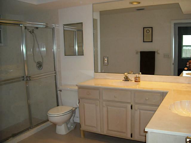 5 Miramar Road Sewall's Point, FL 34996 - Photo 13 of 24 a bathroom with a sink a toilet and shower