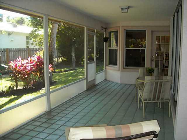 5 Miramar Road Sewall's Point, FL 34996 - Photo 14 of 24 a view of a porch with chairs and dining table