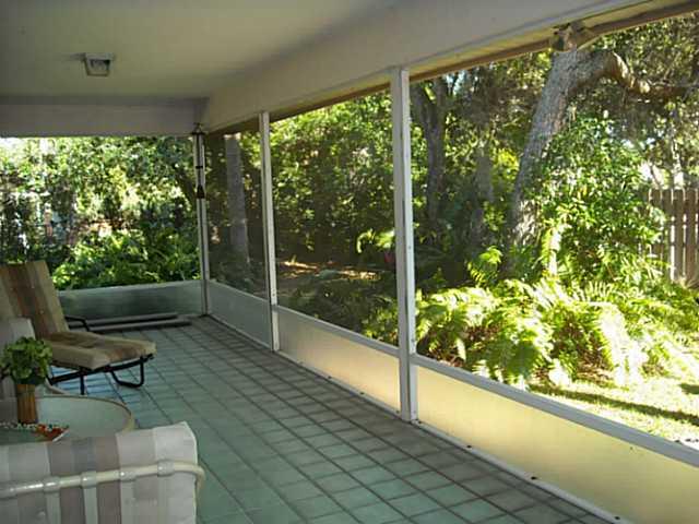 5 Miramar Road Sewall's Point, FL 34996 - Photo 15 of 24 a living room filled with furniture and a large window