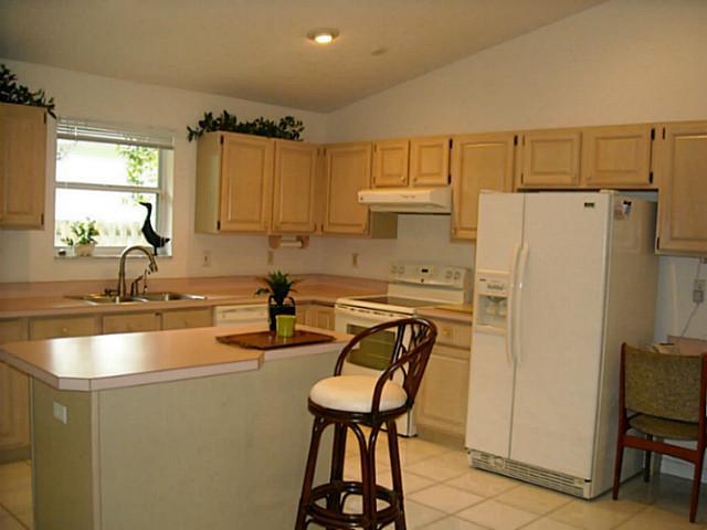 5 Miramar Road Sewall's Point, FL 34996 - Photo 5 of 24 a kitchen with refrigerator cabinets and a sink