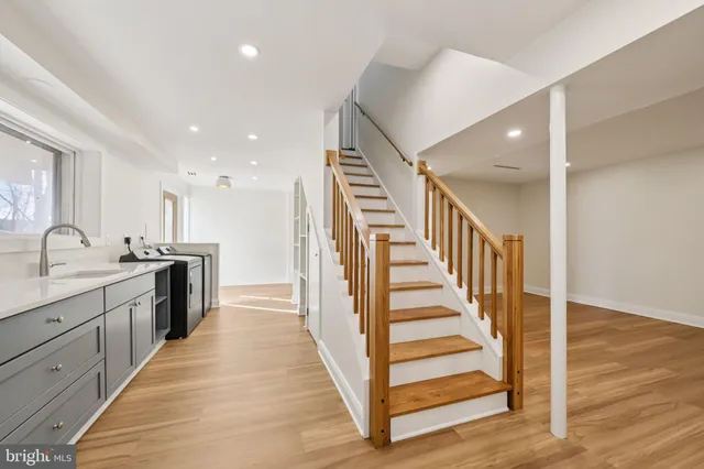 a view of a kitchen with sink and wooden floor