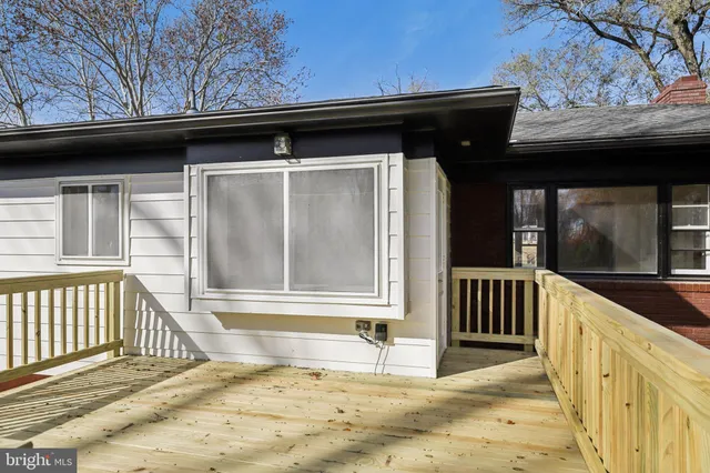 a view of a porch with a table and chairs