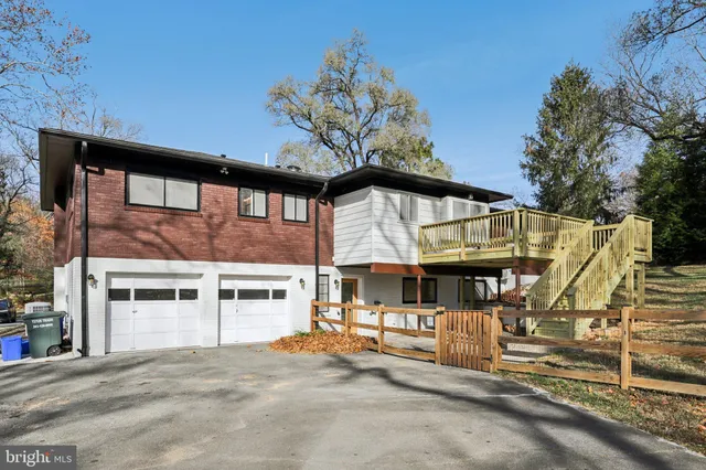 a view of a house with a large windows and plants