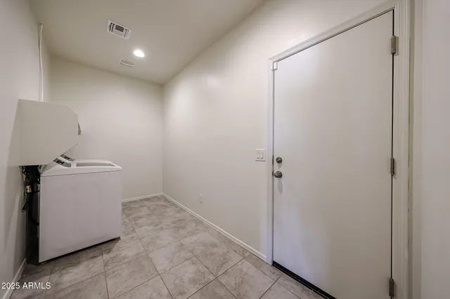 a view of storage and utility room with washer and dryer