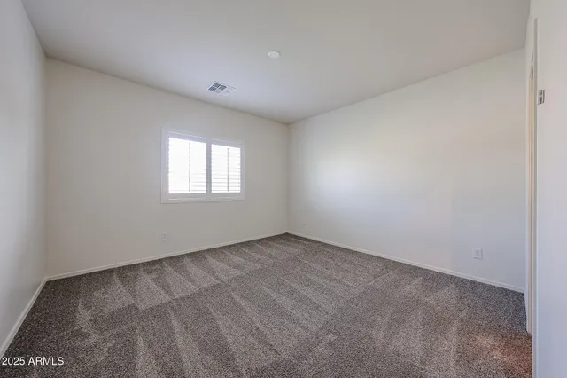 a view of an empty room and a window