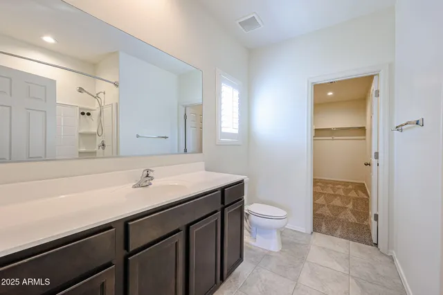 a bathroom with a shower and a sink