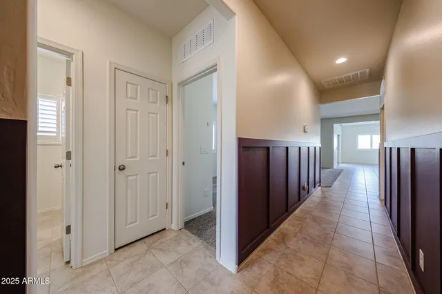 a view of a hallway with wooden cabinets