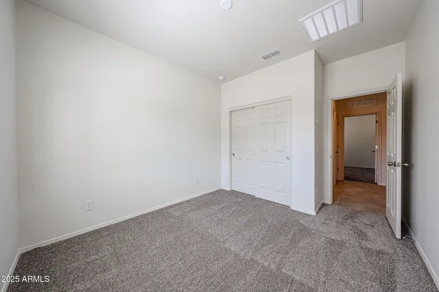 an empty room with closet area