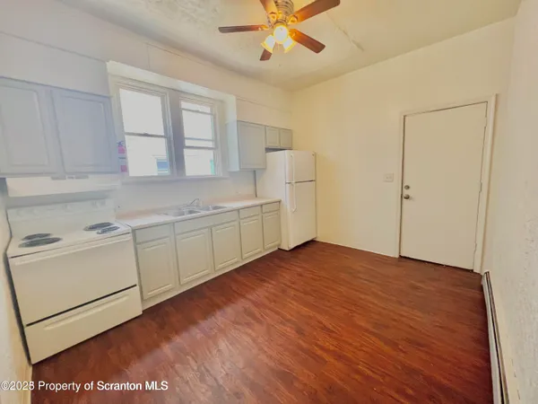 a view of a livingroom with an empty kitchen