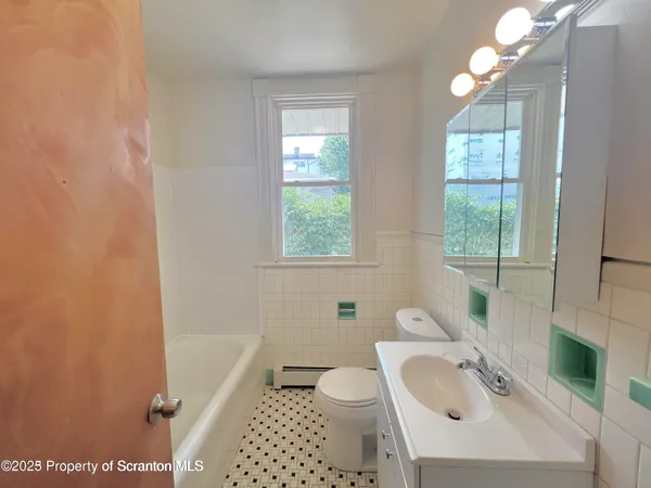 a bathroom with a sink a toilet and tub