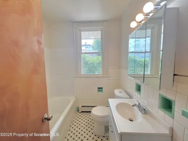 a bathroom with a sink a toilet and tub