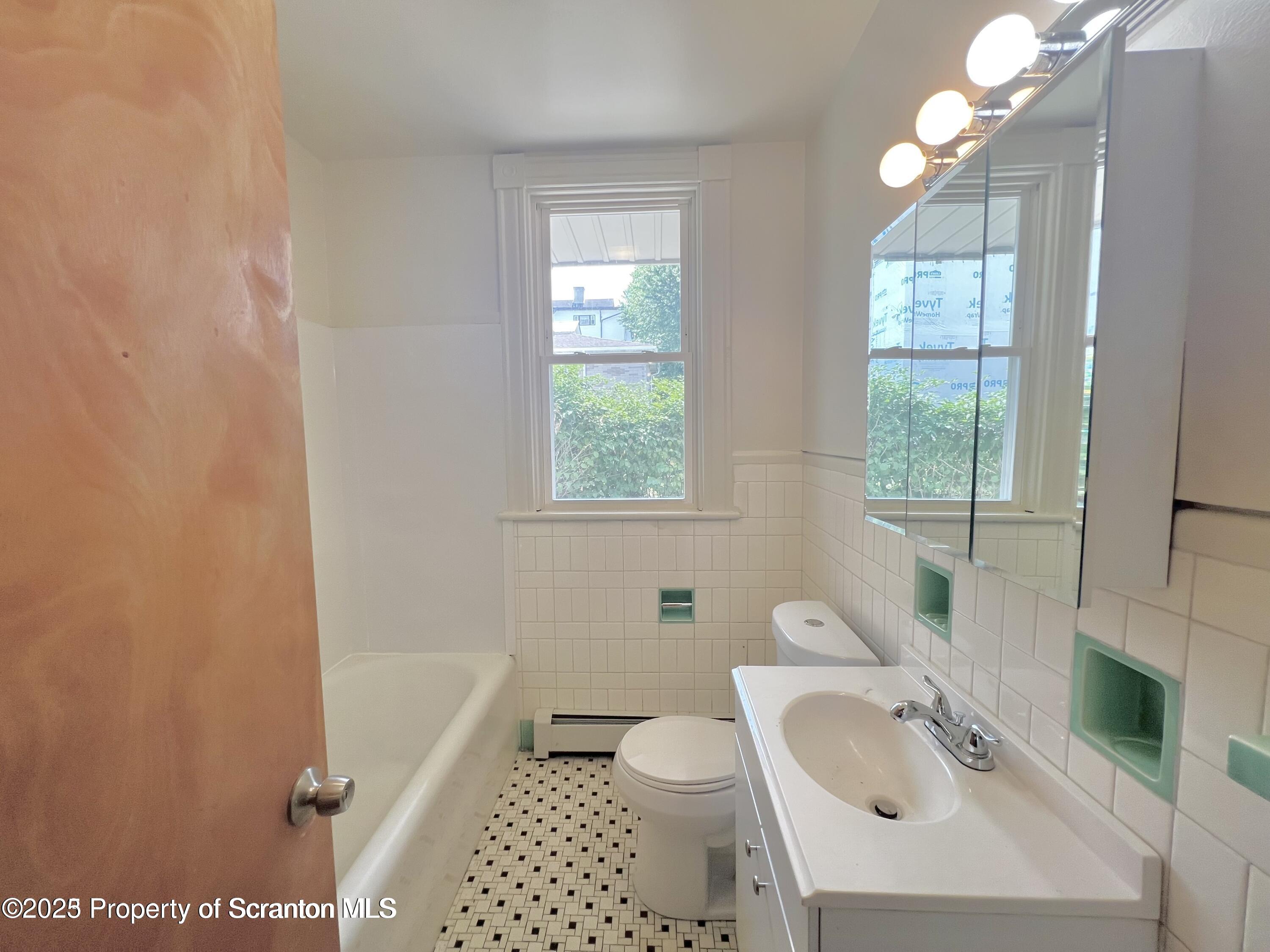 1930 Boulevard Avenue, Unit 1 Scranton, PA 18509 - Photo 3 of 9 a bathroom with a sink a toilet and tub