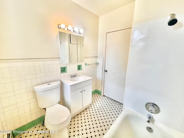 a bathroom with a sink toilet a mirror and shower