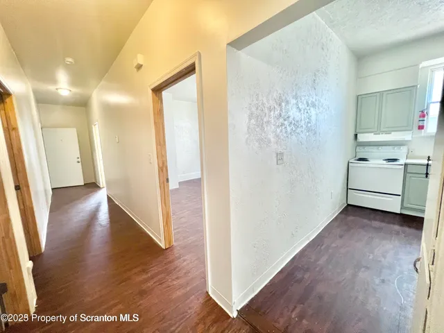 a view of hallway with wooden floor