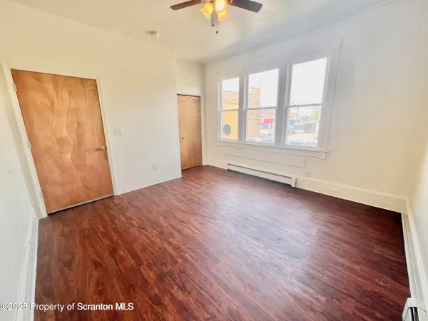 wooden floor in an empty room with a window