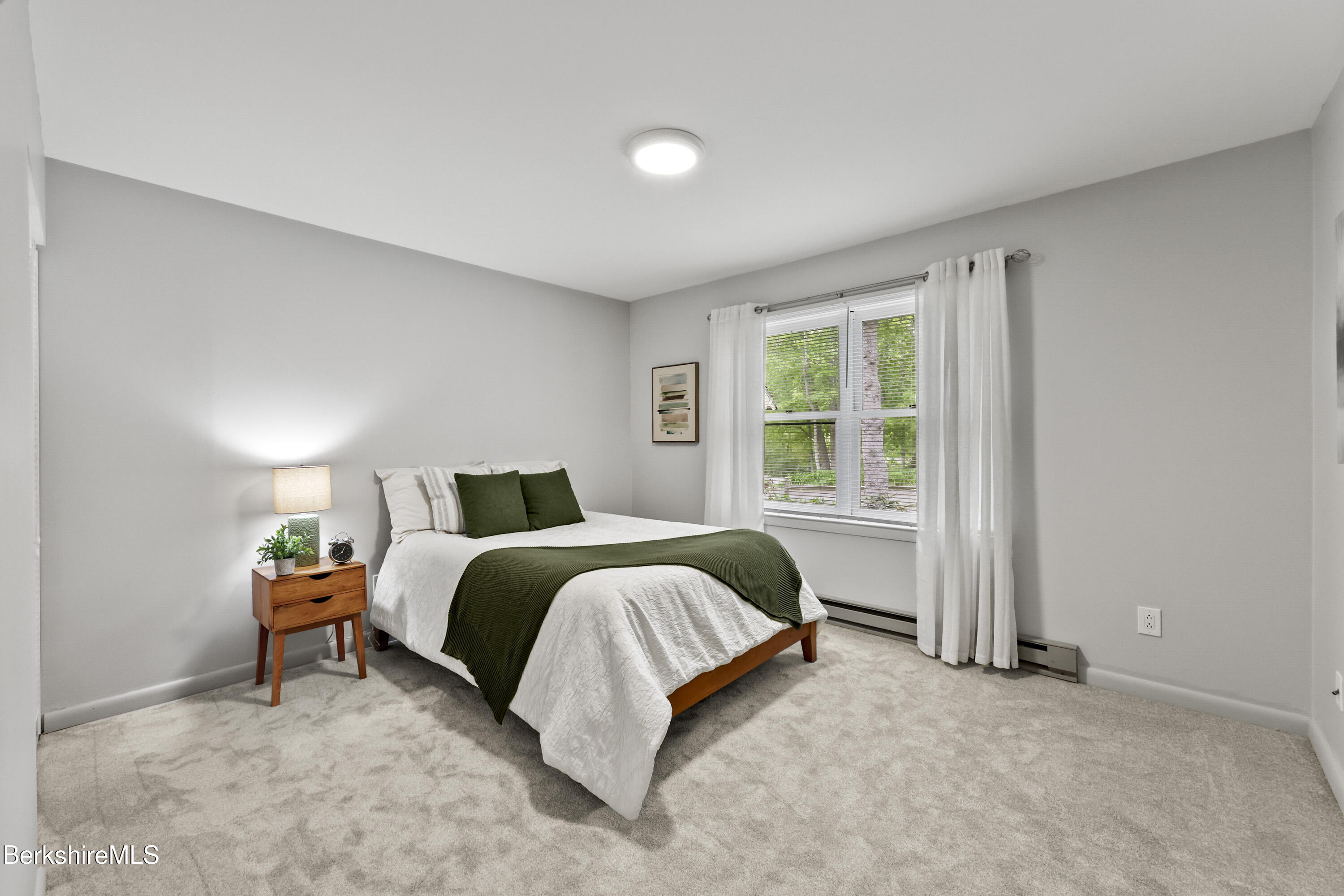 94 Corey Road, Unit D Hancock, MA 01237 - Photo 12 of 45 a spacious bedroom with a bed and a window