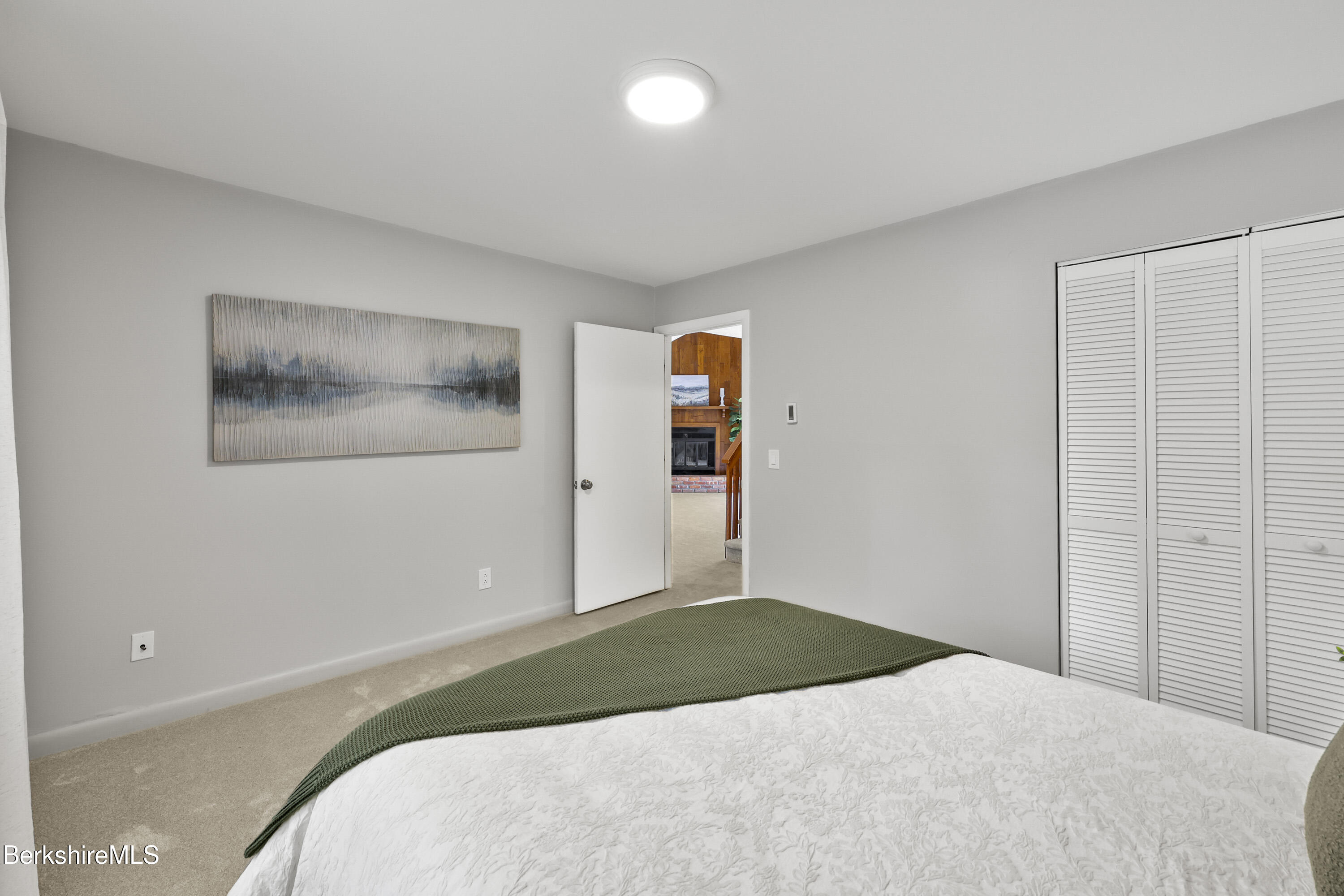 94 Corey Road, Unit D Hancock, MA 01237 - Photo 13 of 45 a bedroom with a bed and a painting on the wall