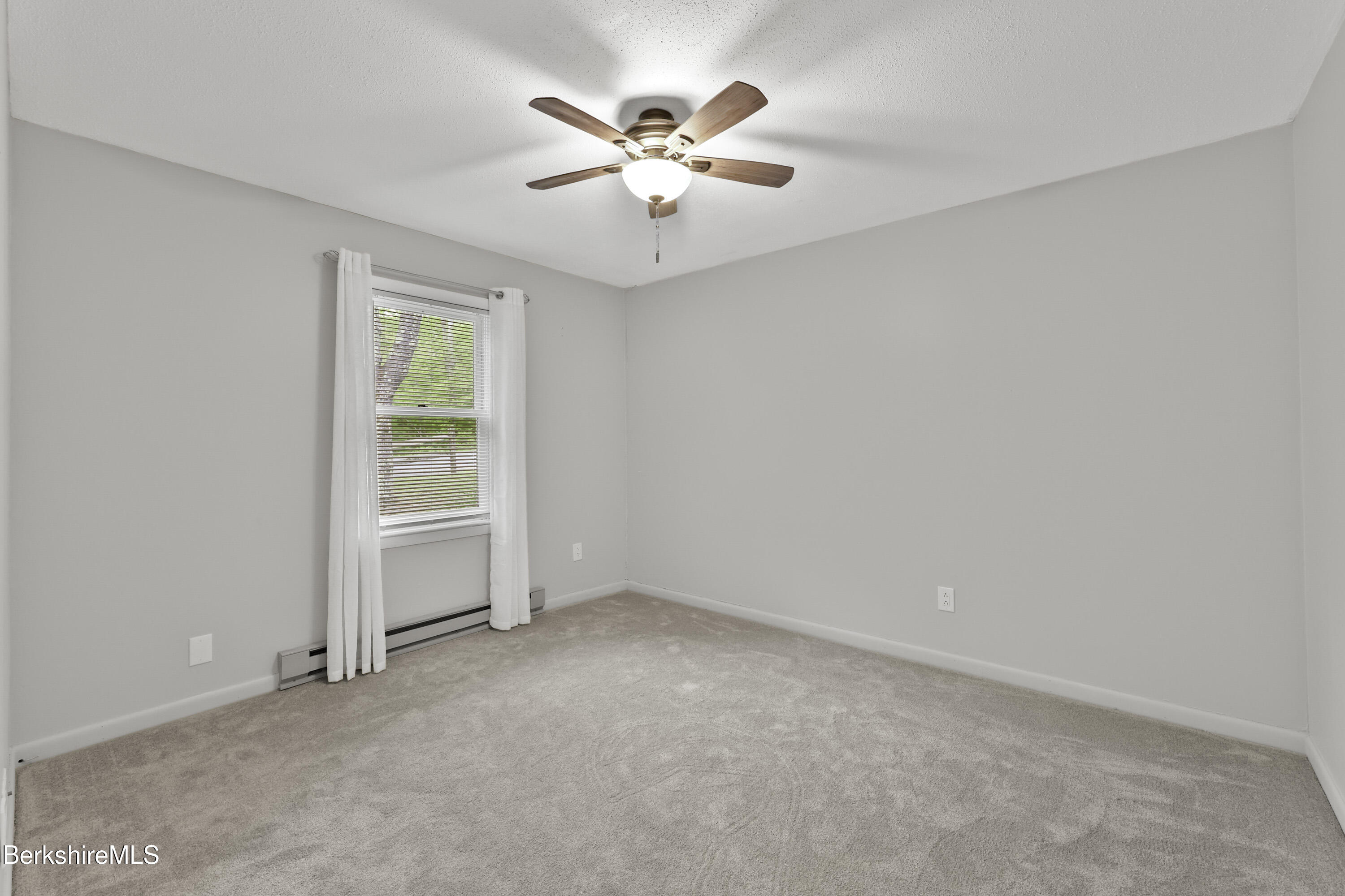 94 Corey Road, Unit D Hancock, MA 01237 - Photo 14 of 45 an empty room with closet and fan