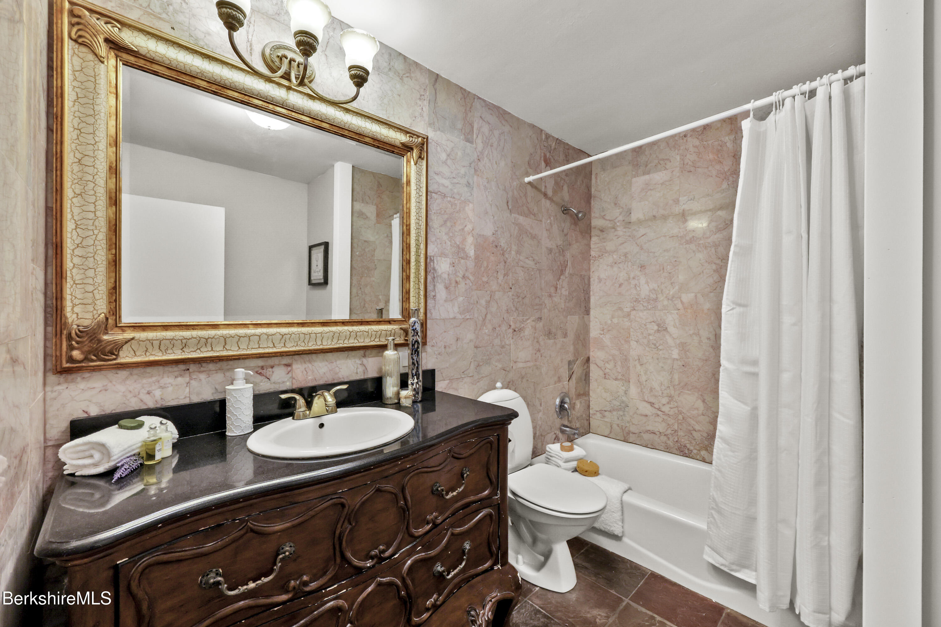 94 Corey Road, Unit D Hancock, MA 01237 - Photo 16 of 45 a bathroom with a toilet a sink and a mirror