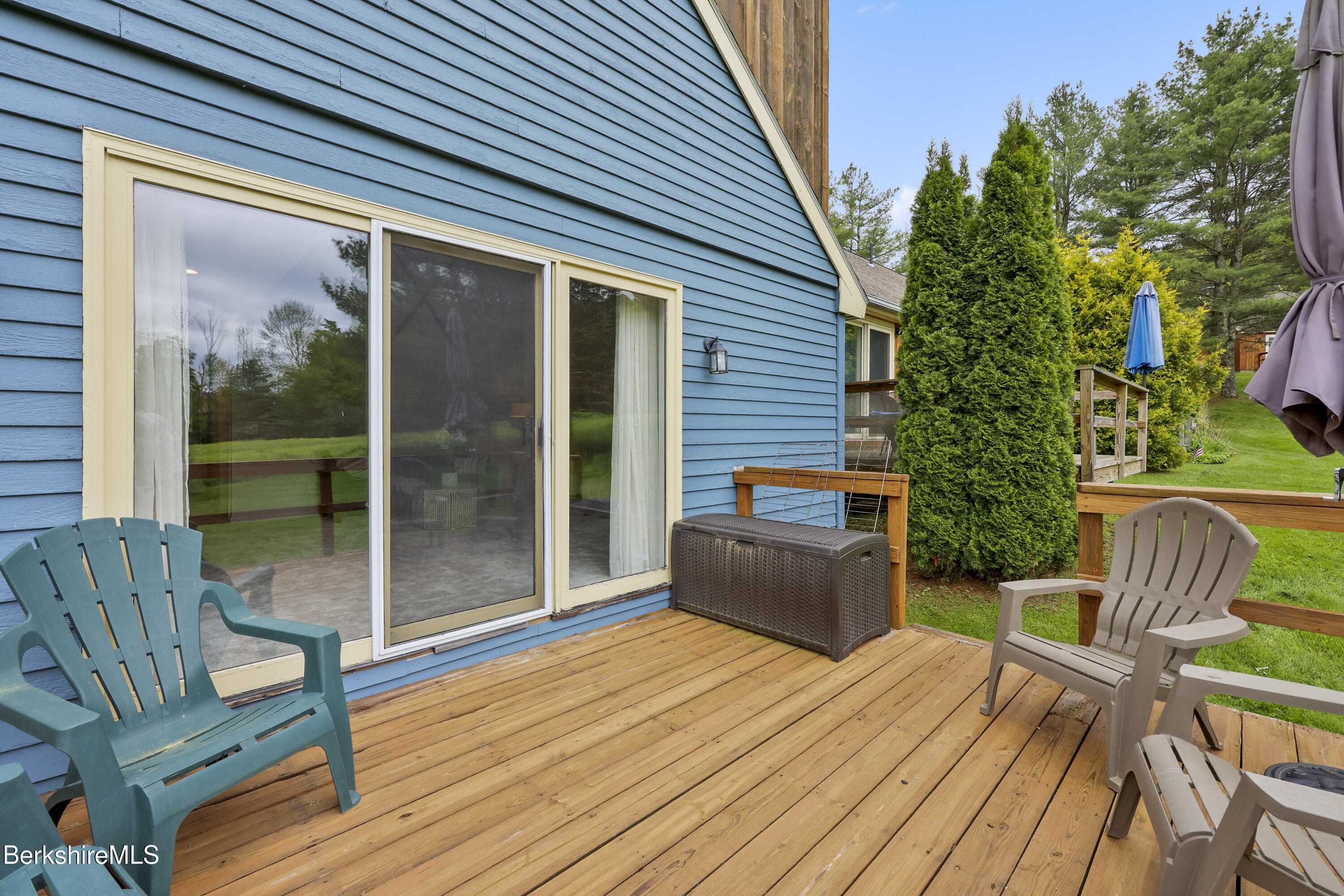94 Corey Road, Unit D Hancock, MA 01237 - Photo 23 of 45 a balcony with furniture and wooden floor