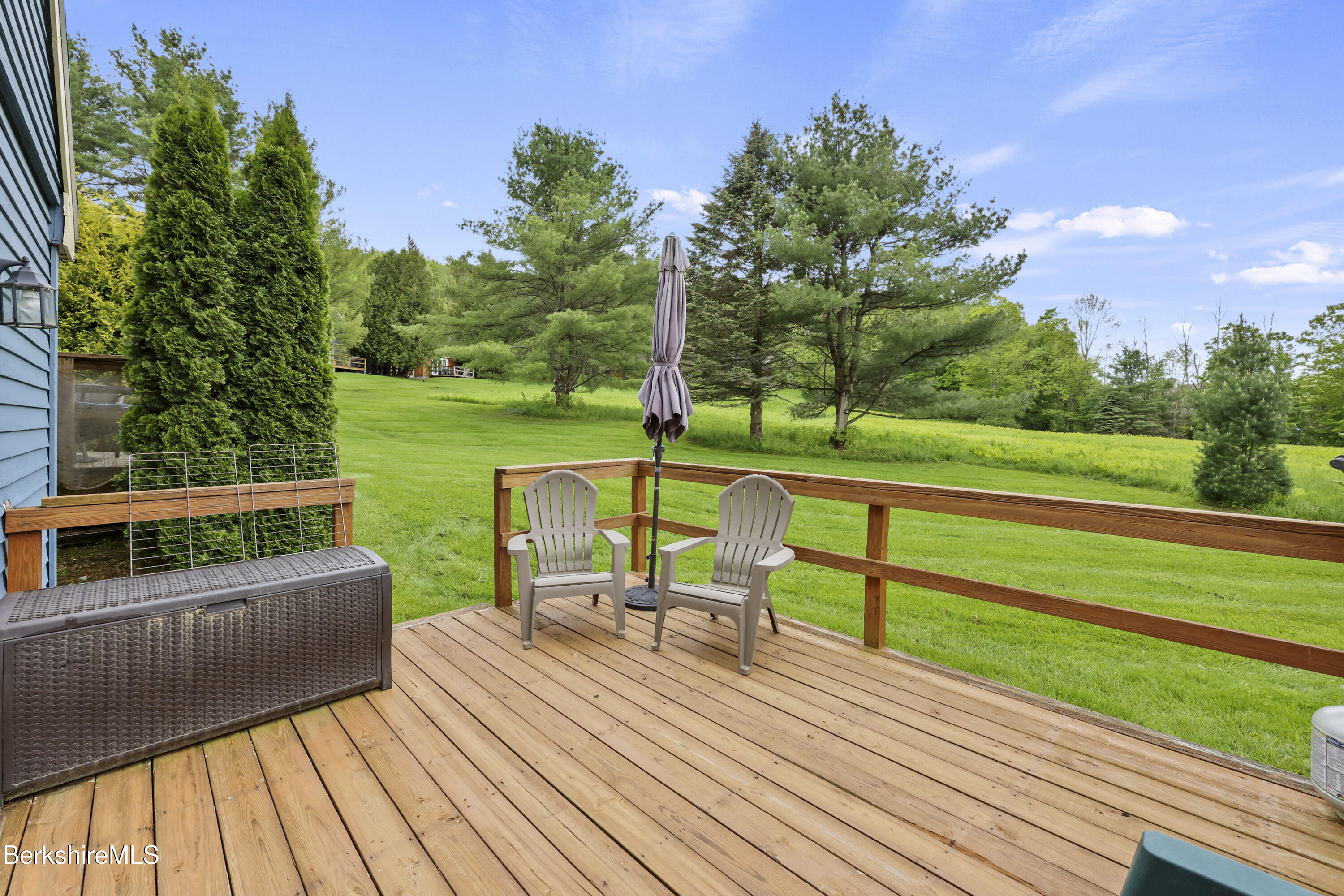94 Corey Road, Unit D Hancock, MA 01237 - Photo 25 of 45 a view of a deck with chairs wooden floor and fence