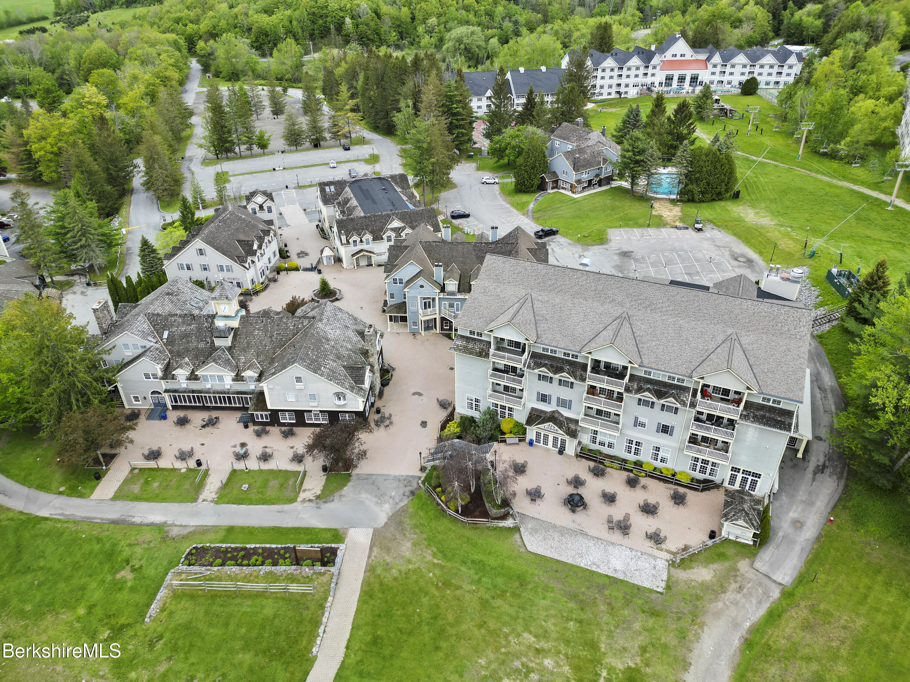 94 Corey Road, Unit D Hancock, MA 01237 - Photo 39 of 45 an aerial view of a house with a garden and statue