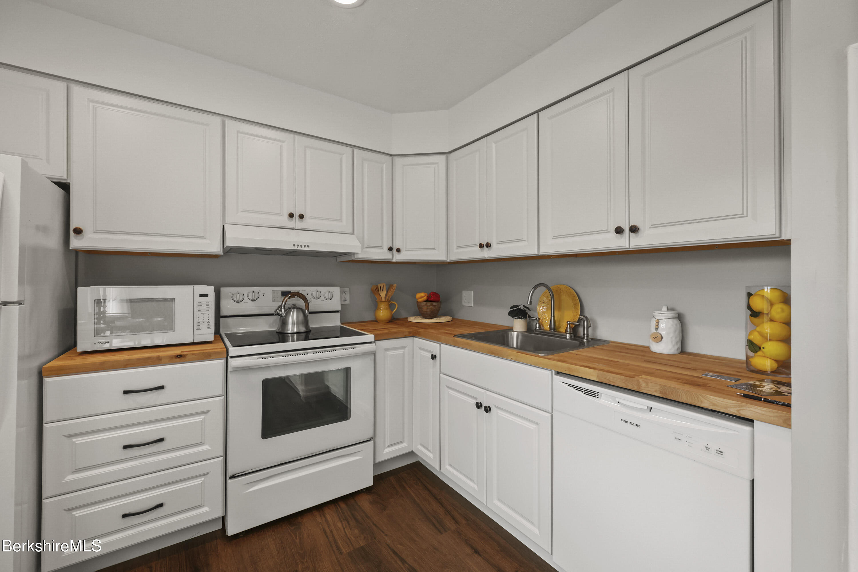 94 Corey Road, Unit D Hancock, MA 01237 - Photo 8 of 45 a kitchen with granite countertop white cabinets and white appliances