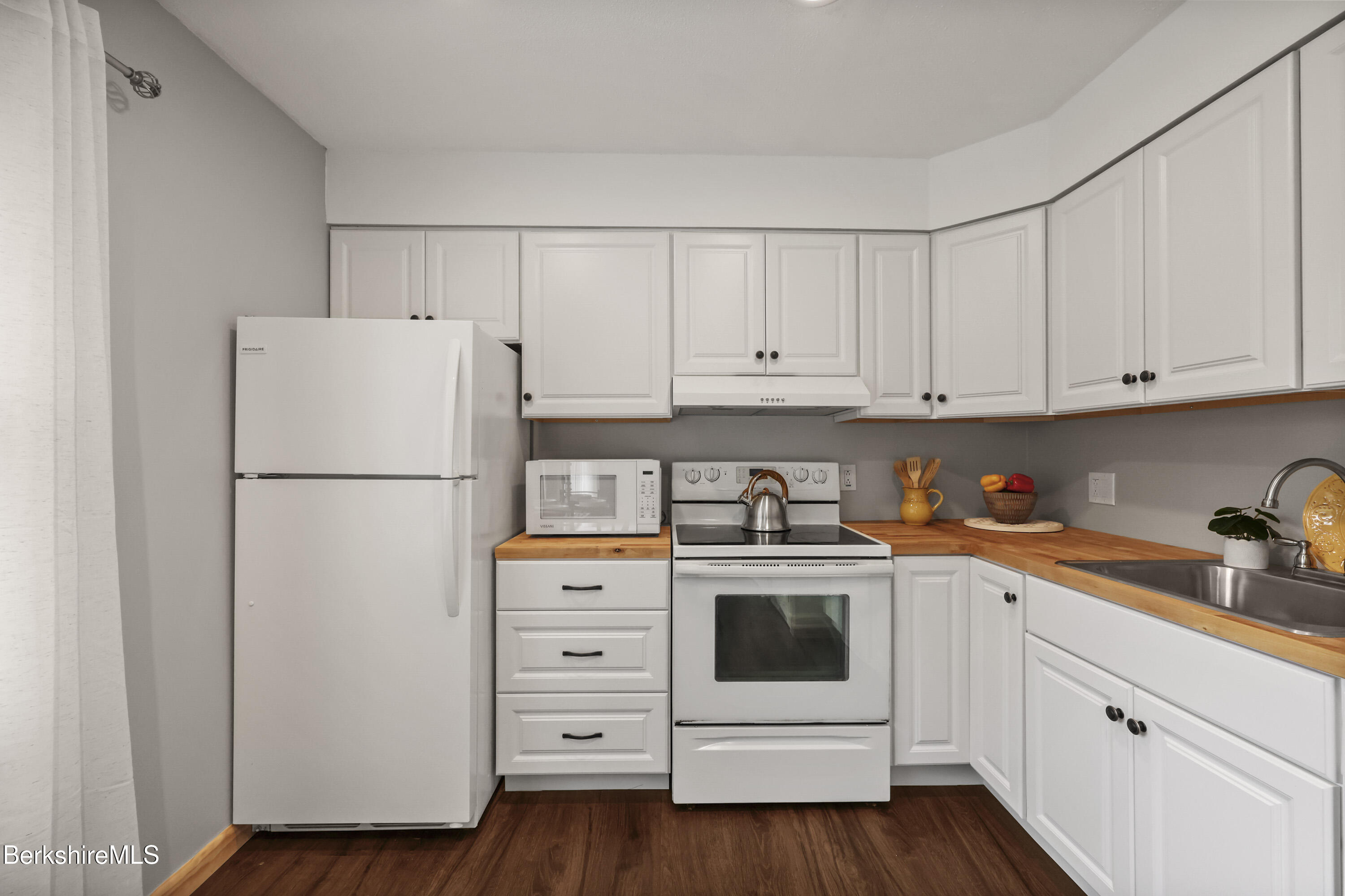 94 Corey Road, Unit D Hancock, MA 01237 - Photo 9 of 45 a kitchen with cabinets stainless steel appliances and wooden floor