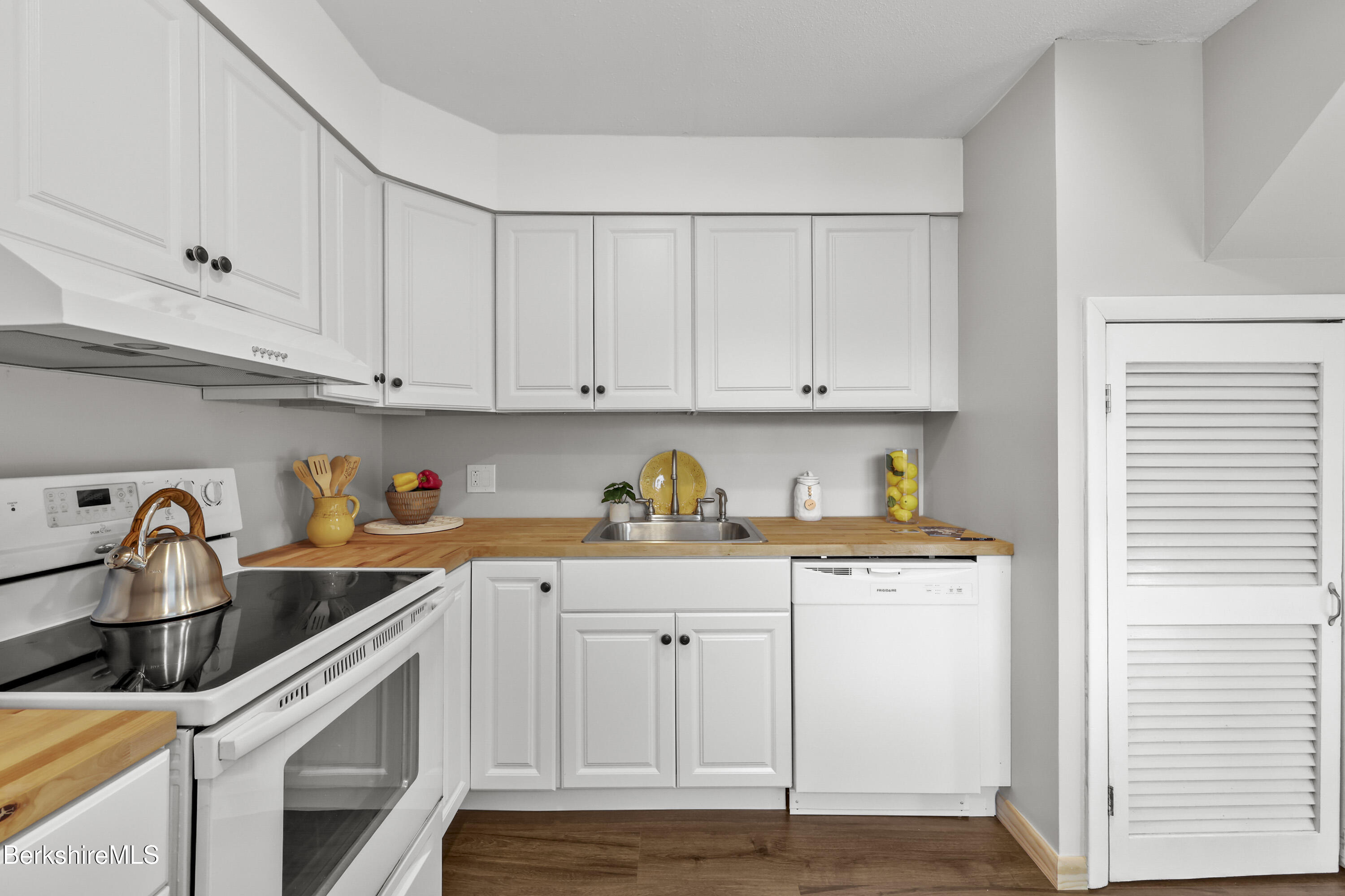 94 Corey Road, Unit D Hancock, MA 01237 - Photo 10 of 45 a kitchen with granite countertop white cabinets and white appliances