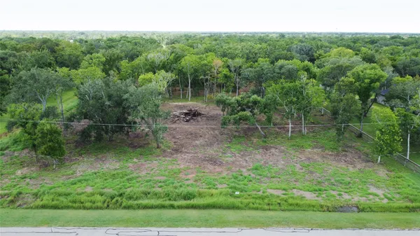 a view of a wooden fence and trees in the background