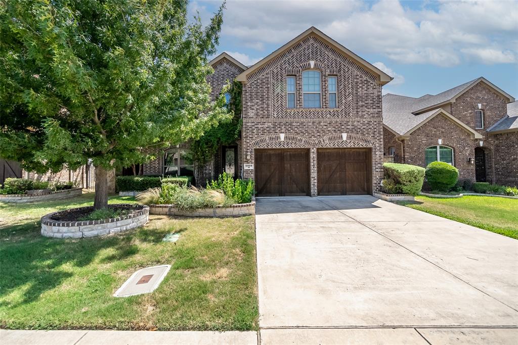 6808 Cache Court Irving, TX 75039 - Photo 1 of 1 a front view of a house with a yard and garage