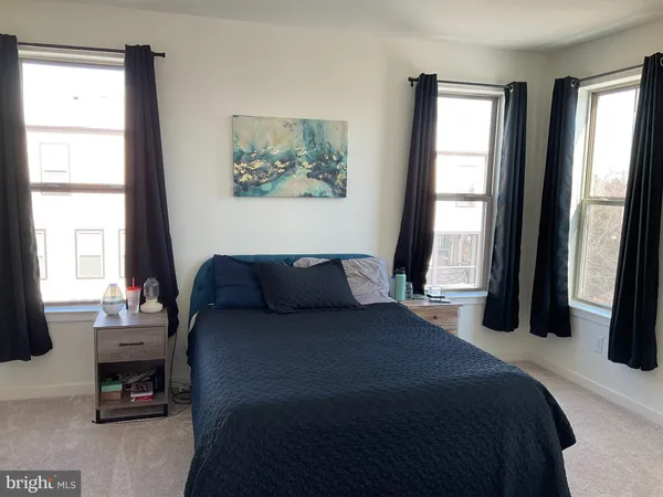 a bedroom with a bed a couch and a window