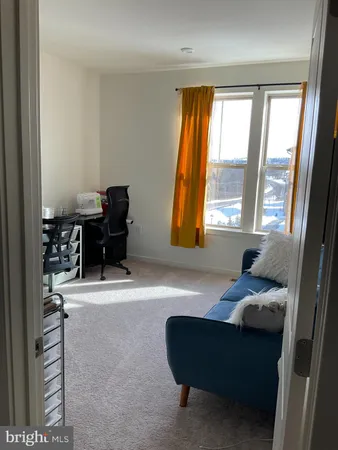 a living room with furniture and a piano table