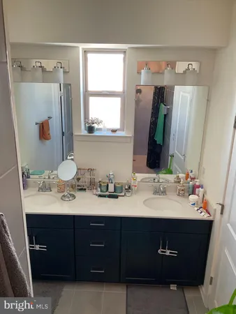 a bathroom with a double vanity sink and mirror