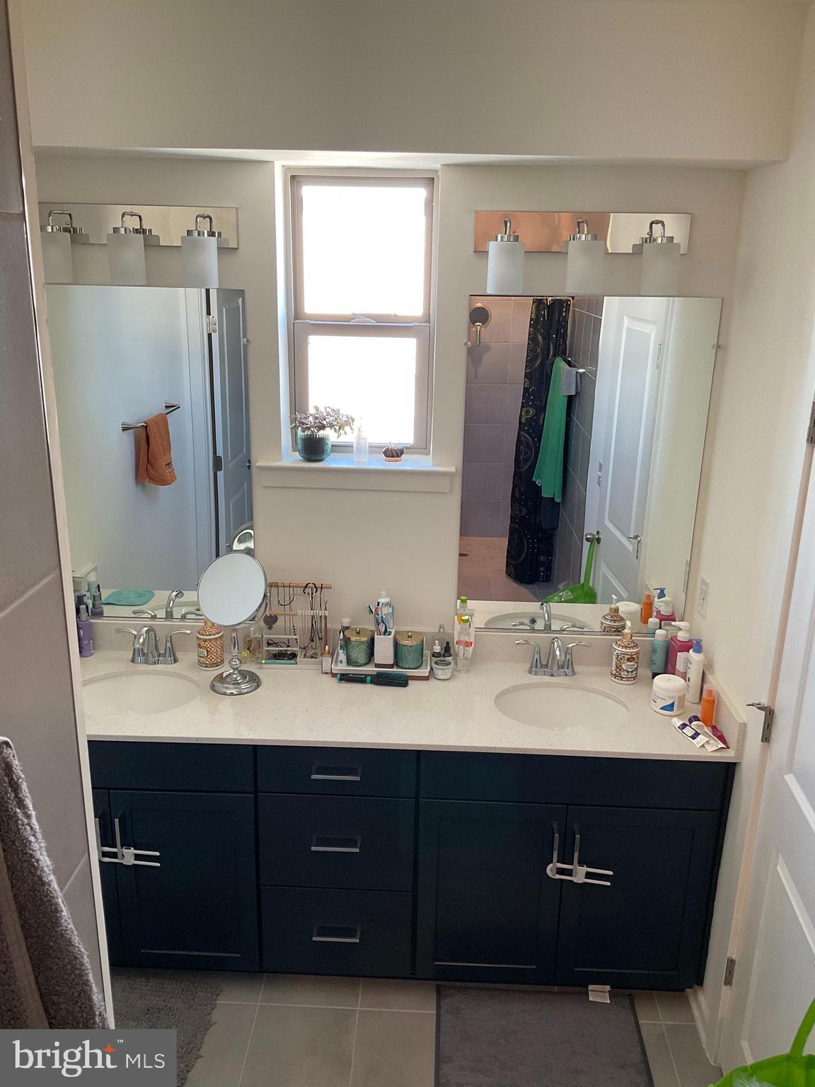 45968 Swallow Terrace Sterling, VA 20165 - Photo 16 of 27 a bathroom with a double vanity sink and mirror