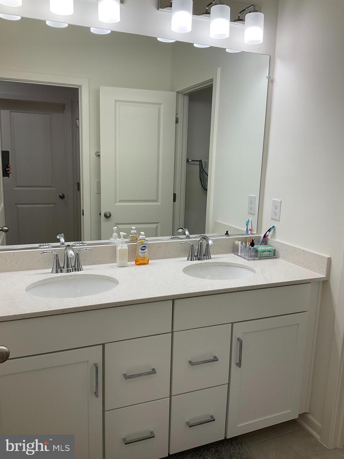 45968 Swallow Terrace Sterling, VA 20165 - Photo 19 of 27 a bathroom with a sink and a mirror