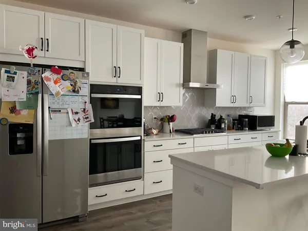 a kitchen with cabinets and white appliances
