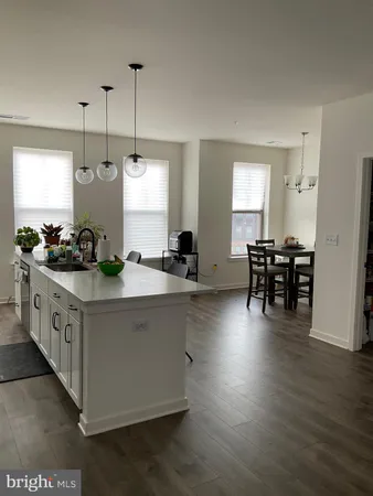 a kitchen with stainless steel appliances granite countertop sink stove and wooden floor