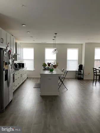 a view of a kitchen with furniture and wooden floor