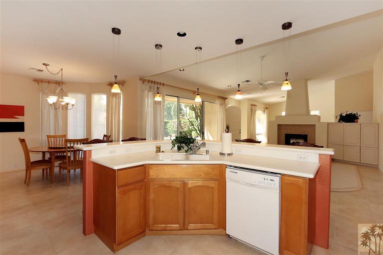 78780 Rio Seco La Quinta, CA 92253 - Photo 14 of 37 a large white kitchen with a sink and dishwasher a stove with wooden floor