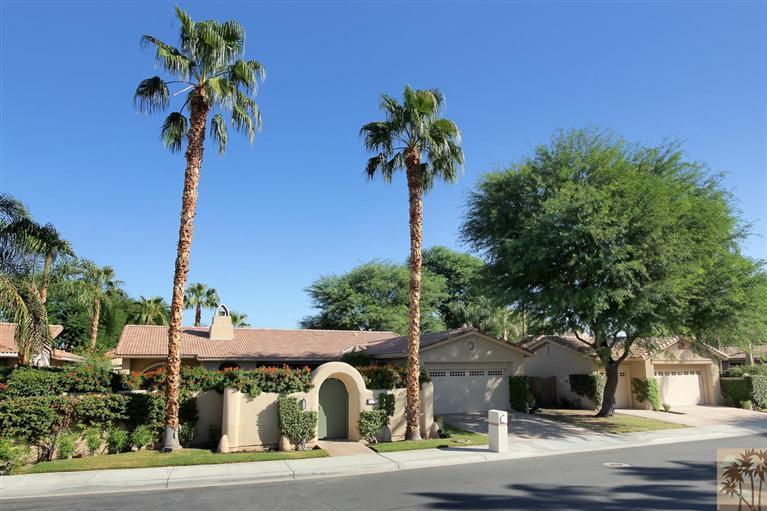 78780 Rio Seco La Quinta, CA 92253 - Photo 2 of 37 a front view of a house with a yard and palm trees