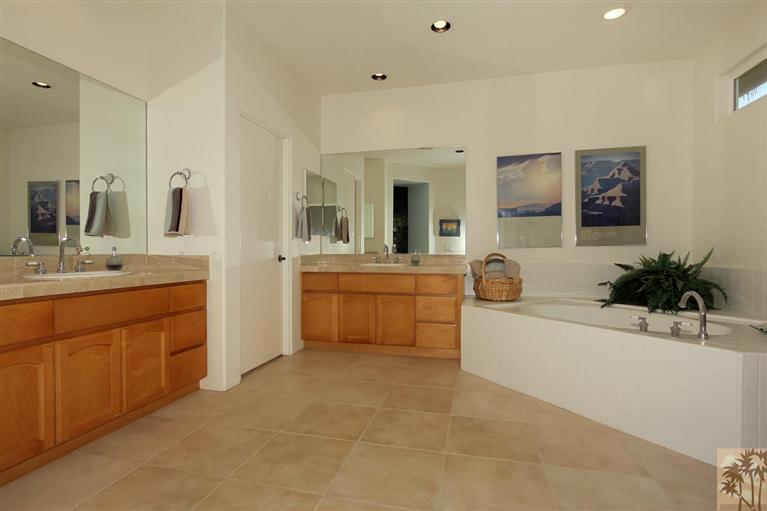 78780 Rio Seco La Quinta, CA 92253 - Photo 27 of 37 a bathroom with a sink a vanity a mirror a bathtub and vanity