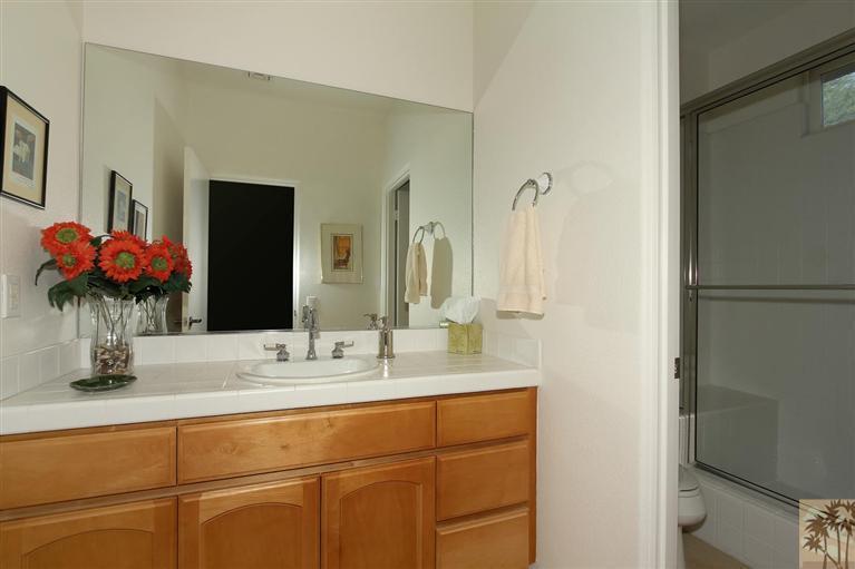 78780 Rio Seco La Quinta, CA 92253 - Photo 30 of 37 a bathroom with a double vanity sink and a mirror