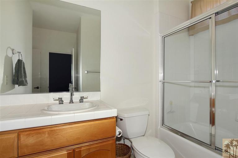 78780 Rio Seco La Quinta, CA 92253 - Photo 33 of 37 a bathroom with a granite countertop sink toilet and shower