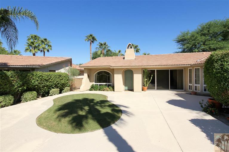 78780 Rio Seco La Quinta, CA 92253 - Photo 7 of 37 a front view of a house with a garden